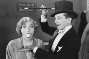 1920s magician and woman with egg in mouth